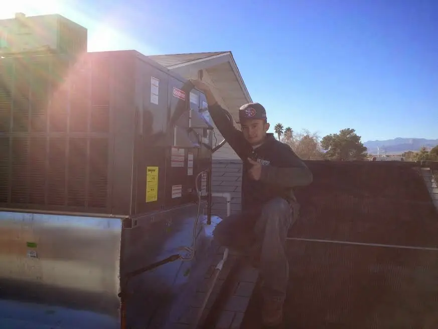 HVAC technician performing HVAC Inspection on a rooftop unit in Pleasure Point